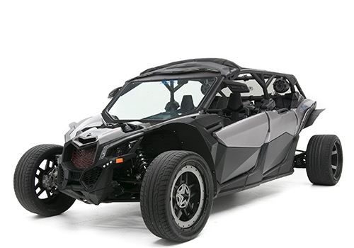A black off-road side-by-side with an aggressive stance, large rugged tires and a roll cage, built for high-performance adventure riding.